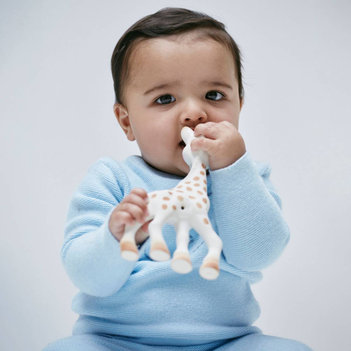  Baby boy wearing blue babygrow